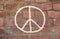 Peace sign drawing on red brick wall