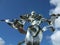 Peace statue in Normandy, France - silver woman holding dove