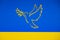 Peace in Ukraine in War after Attack from Russia. Dove as a symbol of peace. On a yellow-blue background in the colors of the