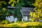 Peaceful abandoned old cottage at summer sunset in the woods