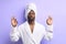 Peaceful african man doing yoga and meditate iolated over purple hite background