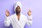 Peaceful african man doing yoga and meditate iolated over purple hite background