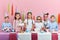 Peaceful attractive children standing at the table during birthday party