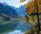 Peaceful autumn Alps mountain lake with clear transparent water and reflections. Almsee lake, Upper Austria