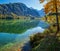 Peaceful autumn Alps mountain lake with clear transparent water and reflections. Almsee lake, Upper Austria