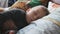 Peaceful baby boy lying on a bed while sleeping. Family, motherhood, love, health and care concept.