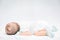 Peaceful baby lying on a bed while sleeping.