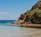 Peaceful beach with golden island and sand at sunset, sea with calm water, Greece.