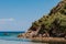 Peaceful beach with golden island and sand at sunset, sea with calm water, Greece.