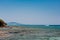 Peaceful beach with golden island and sand at sunset, sea with calm water, Greece