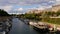 Peaceful cityscape with the promenade of Canal Saint-Martin in the east of Paris downtown with docking boats.