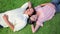 Peaceful couple napping while lying on the grass