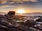 Peaceful dawn at Elgol bay. Low angle overlooking of offshore rocks and smooth sea, mountains