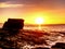 Peaceful dawn at Elgol bay. Low angle overlooking of offshore rocks and smooth sea, mountains