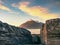 Peaceful dawn at Elgol bay. Low angle overlooking of offshore rocks and smooth sea, mountains