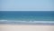 Peaceful empty beach in summer with white sand and turquoise water