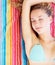 Peaceful female in bikini relaxing on a colorful towel. Cute young bikini woman lying relaxed on a colorful towel.