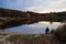 Peaceful fishing on the lake in autumn evening.