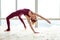 Peaceful good-looking woman using her body flexibility for extreme stretching