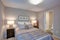 Peaceful gray blue bedroom interior with ensuite bathroom