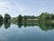 Peaceful lake with clouds and trees reflected in water