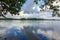 Peaceful lake in summer under stormy sky