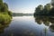 peaceful lake, with tranquil reflections and a distant view of the surrounding landscape