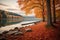 A peaceful lakeside scene with trees in their vibrant fall colors