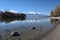 peaceful lakeside, with snow-capped mountain in the background