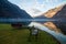 Peaceful landscape with park benches in front of calm lake, Hallstatt mountains village in Austria