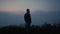 Peaceful man enjoying foggy landscape in morning. Guy standing on mountain