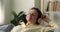 Peaceful mature lady in wireless earphones listen to audio book