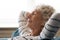 Peaceful mindful mature senior grandmother daydreaming at home.