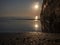 Peaceful morning sea with the sun rising and a stone pier