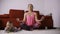 Peaceful mother meditating in lotus pose near baby