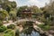 peaceful pagoda garden with water features, elegant greenery, and artwork