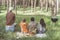 Peaceful people arranging picnic in the wood