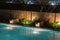 Peaceful pool reflections amid mood lighting and lush greenery g