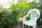 Peaceful porch setting surrounded by Morning Glory vines, Pink Geraniums and tall Castor Bean plants