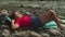 Peaceful pretty african american woman backpacker relaxing on mountain riverbank on trek