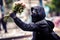 Peaceful Protester Holding a Bouquet of Flowers during a Flower Revolution