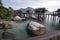 Peaceful and quiet early morning view of the boulders along the wooden houses on stilts at the Straits of Malacca