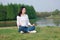 Peaceful quite happy life, Asian Chinese yoga woman girl beauty by lake river sea ocean