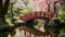 A peaceful red bridge spans across a small pond in a park, offering a serene pathway between two beautiful green areas, A tranquil