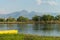 Peaceful river flow and a yellow fishing boat on the grassy shore