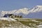 Peaceful rural landscape with traditional Romanian mountainous farm with old barn and haystacks, near Bucegi massif