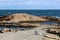 Peaceful scene of rocky shore with waves making their way to the beach