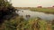 Peaceful scene of the wetlands with the rows of salt storage houses in the horizon