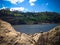 Peaceful Scenery Lake Water Dam And The Hills From Rock Excavation On A Sunny Day