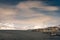 Peaceful shoreline view of Longyearbyen, Norway with snow-capped mountains in the backdrop